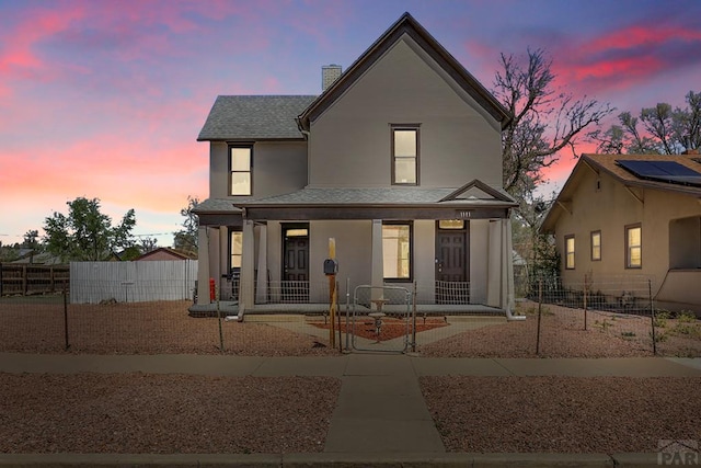 1111 Topaz Pl, Pueblo, CO 81004 - view of front of property with a chimney, fence, a shingled roof, and covered porch