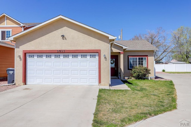 2025 Oneal Cir, Pueblo, CO 81004 - ranch-style home with a garage, stucco siding, and driveway