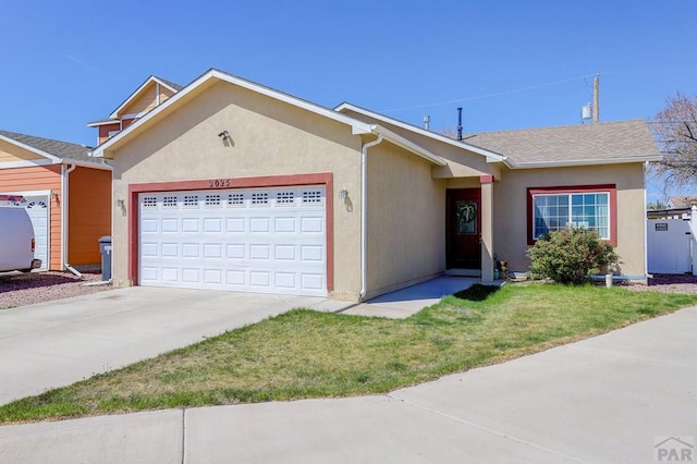 2025 Oneal Cir, Pueblo, CO 81004 - view of front facade featuring an attached garage, concrete driveway, stucco siding, and a front yard