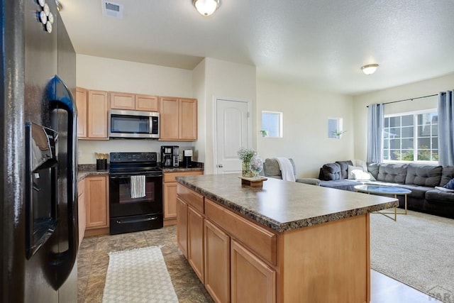 2025 Oneal Cir, Pueblo, CO 81004 - kitchen with black appliances, dark countertops, open floor plan, a center island, and light brown cabinetry