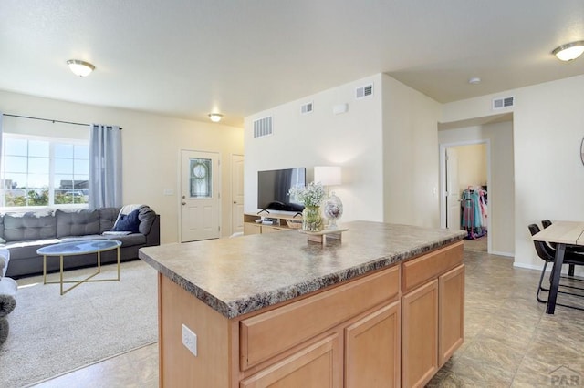 2025 Oneal Cir, Pueblo, CO 81004 - kitchen with open floor plan, a center island, and dark countertops