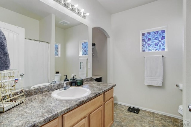 2025 Oneal Cir, Pueblo, CO 81004 - full bathroom with toilet, vanity, baseboards, and curtained shower
