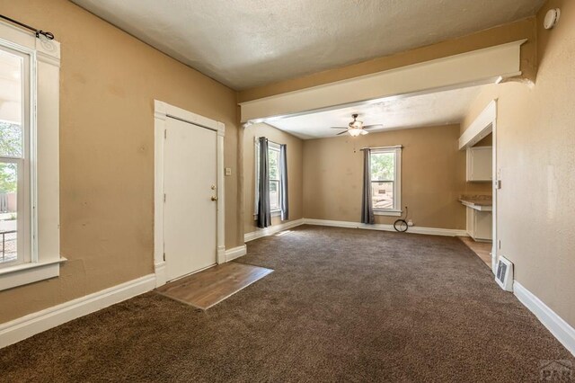 interior space with ceiling fan, carpet, visible vents, and baseboards