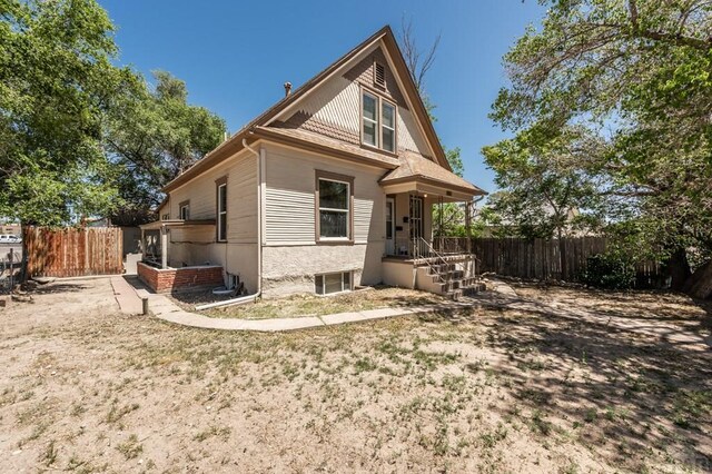 back of house featuring fence