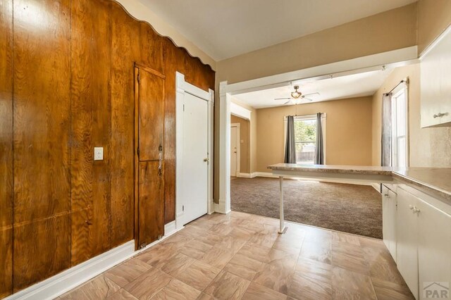 hallway featuring light carpet