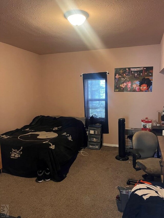 bedroom with carpet floors and a textured ceiling