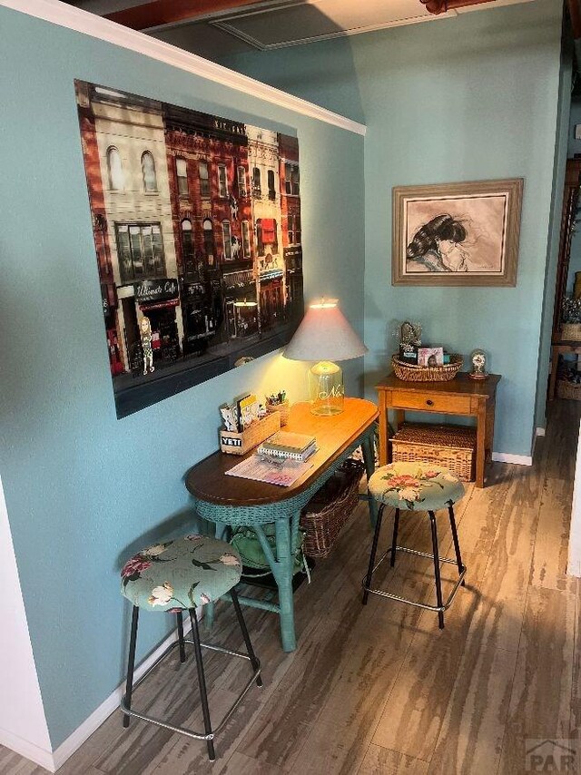 dining space with baseboards and wood finished floors