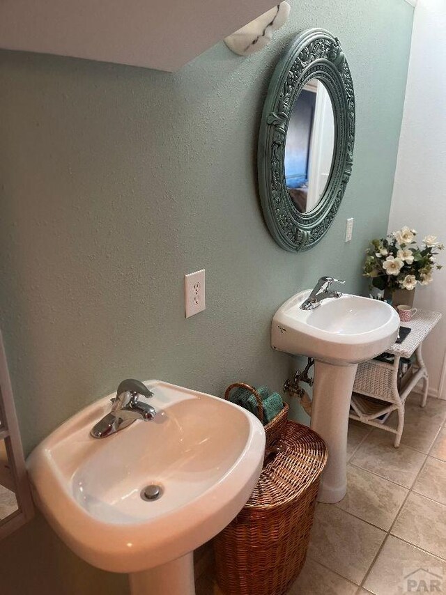 bathroom with tile patterned flooring and a sink