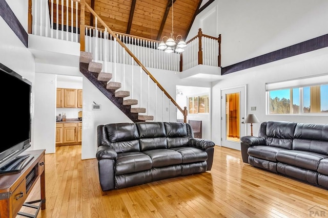 living room with wooden ceiling, light wood finished floors, and stairs