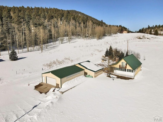 snowy aerial view with a forest view