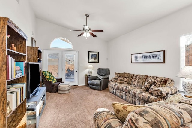 carpeted living area with a healthy amount of sunlight, ceiling fan, and vaulted ceiling