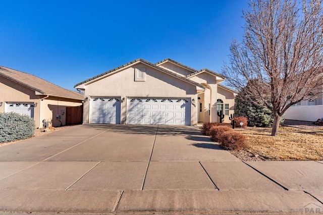 single story home featuring fence, driveway, stucco siding, a garage, and a tile roof