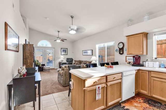 kitchen with dishwasher, a peninsula, light countertops, and vaulted ceiling