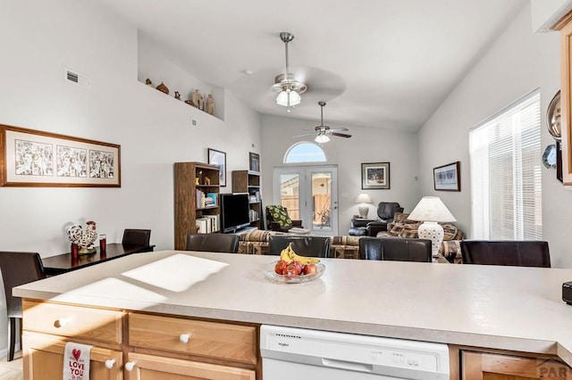 kitchen featuring visible vents, lofted ceiling, white dishwasher, light countertops, and open floor plan