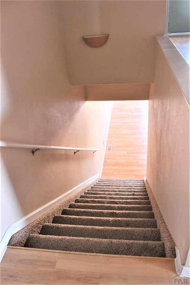 628 S Blakeland Ct, Pueblo West, CO 81007 - stairs with wood finished floors and baseboards