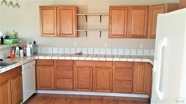 628 S Blakeland Ct, Pueblo West, CO 81007 - kitchen featuring white appliances, open shelves, brown cabinets, tile counters, and dark wood finished floors