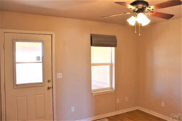 628 S Blakeland Ct, Pueblo West, CO 81007 - foyer with plenty of natural light, a ceiling fan, baseboards, and wood finished floors