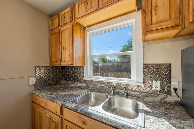 1902 E 12th St, Pueblo, CO 81001 - kitchen featuring a sink, backsplash, and brown cabinets