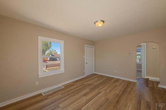 1902 E 12th St, Pueblo, CO 81001 - spare room with arched walkways, wood finished floors, and baseboards