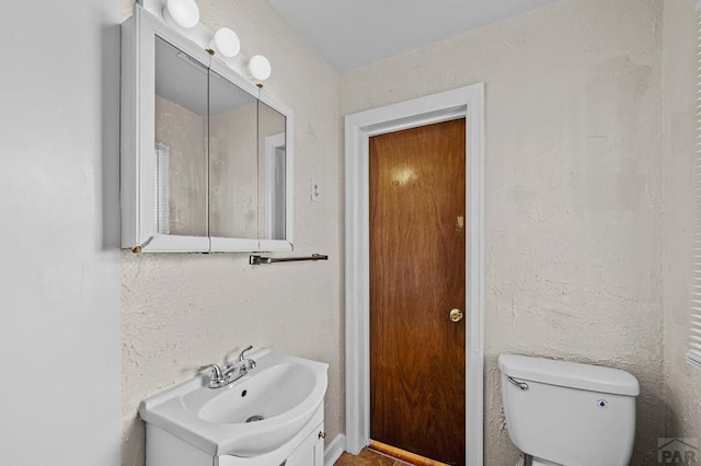 bathroom with toilet and vanity