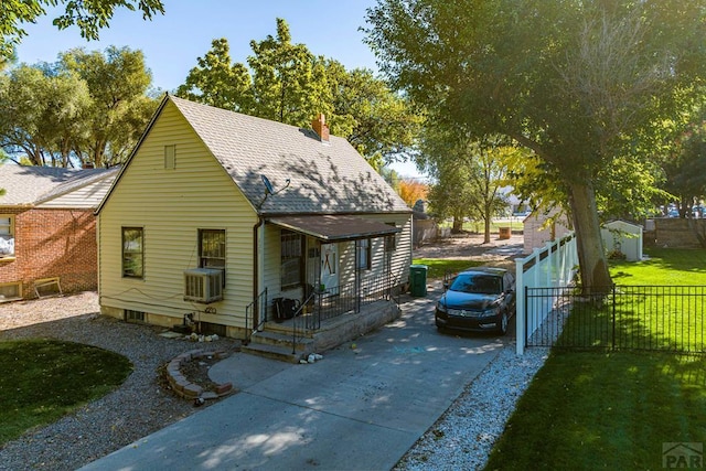 bungalow featuring a chimney, fence, and roof with shingles