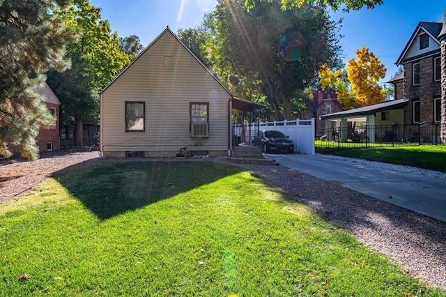 view of property exterior with fence and a lawn