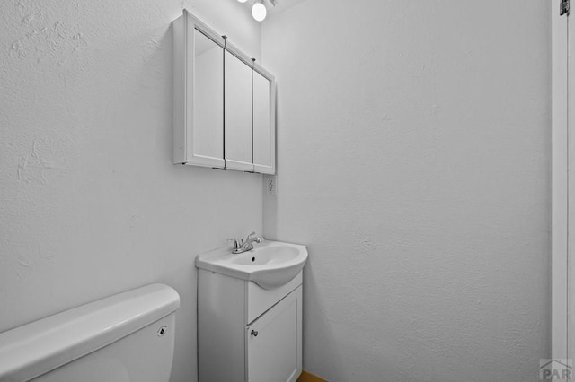 bathroom featuring toilet and vanity