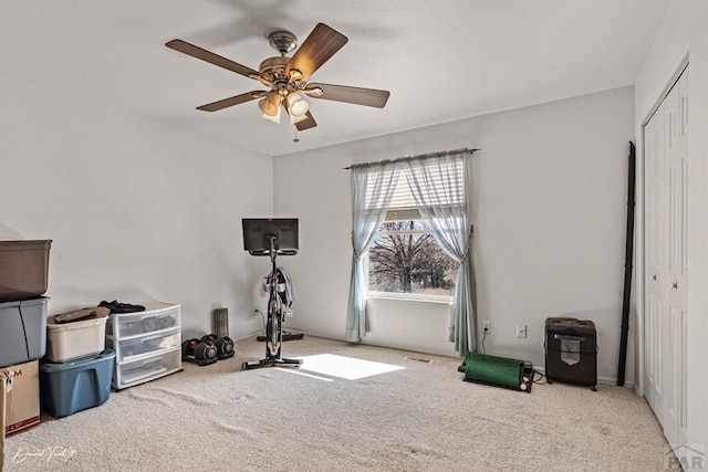 exercise area with ceiling fan, carpet, and visible vents