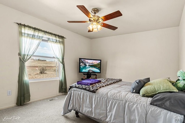 carpeted bedroom with baseboards, visible vents, and ceiling fan