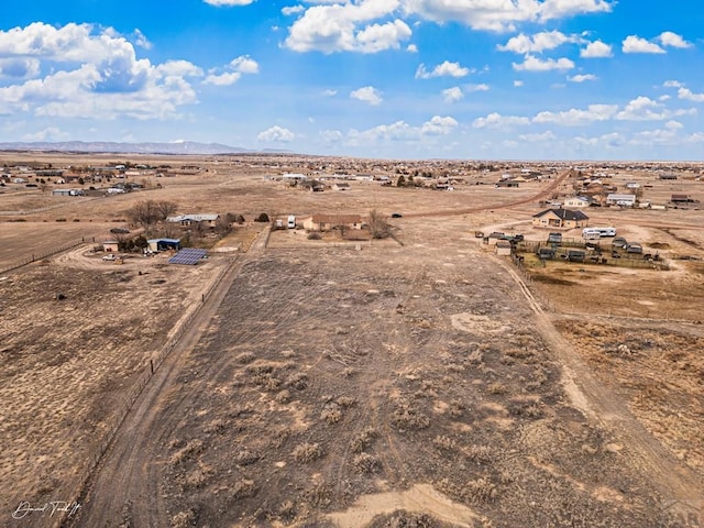 aerial view featuring view of desert, a mountain view, and a rural view