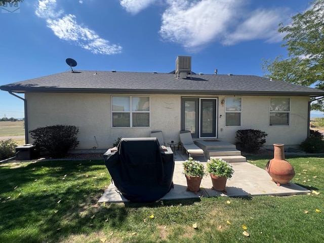 rear view of property with central AC, a shingled roof, a lawn, stucco siding, and a patio area