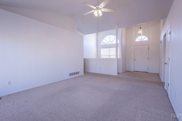 unfurnished room featuring light carpet, high vaulted ceiling, visible vents, and a ceiling fan