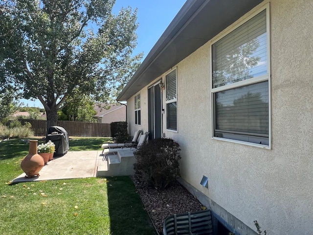 view of yard featuring fence and a patio