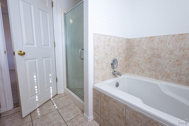 full bathroom with a stall shower, tile patterned flooring, and a bath