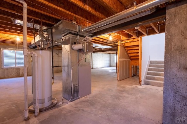 basement with water heater, heating unit, and stairs