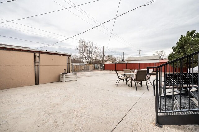 1802 E Routt Ave, Pueblo, CO 81004 - view of patio featuring outdoor dining area and fence