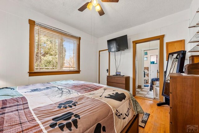 1802 E Routt Ave, Pueblo, CO 81004 - bedroom featuring ceiling fan, light wood finished floors, and a textured ceiling