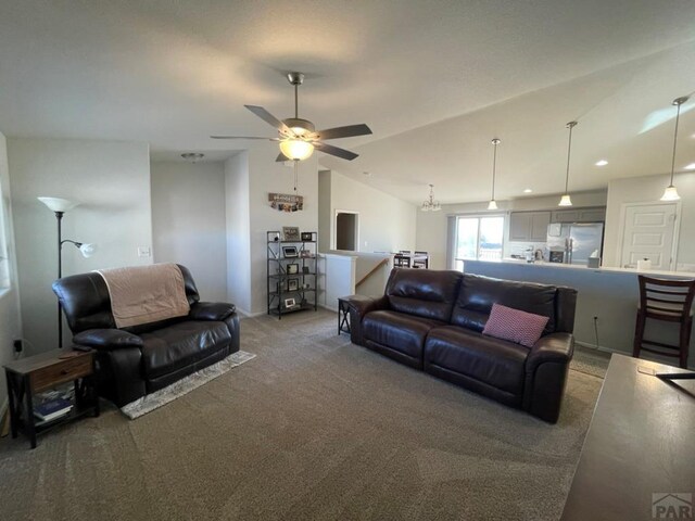 carpeted living room with vaulted ceiling and a ceiling fan