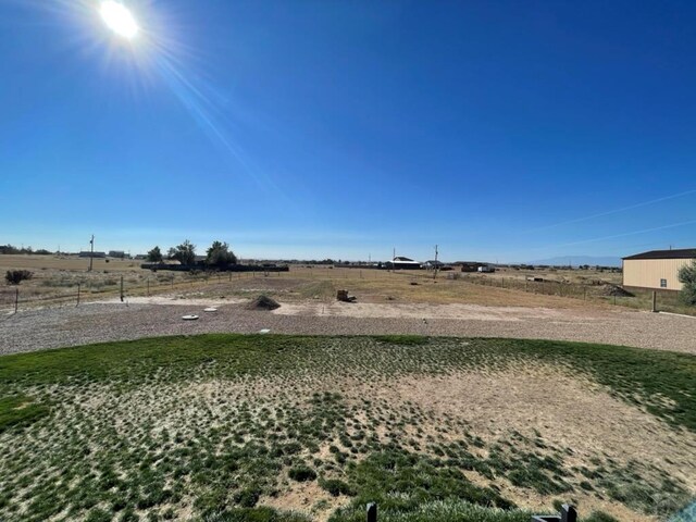 view of yard with a rural view