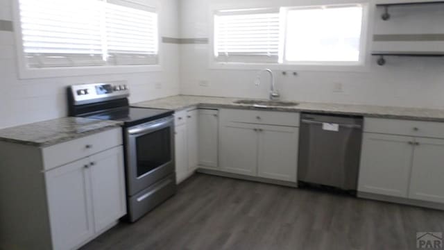 kitchen with open shelves, a sink, white cabinets, stainless steel appliances, and light wood-style flooring