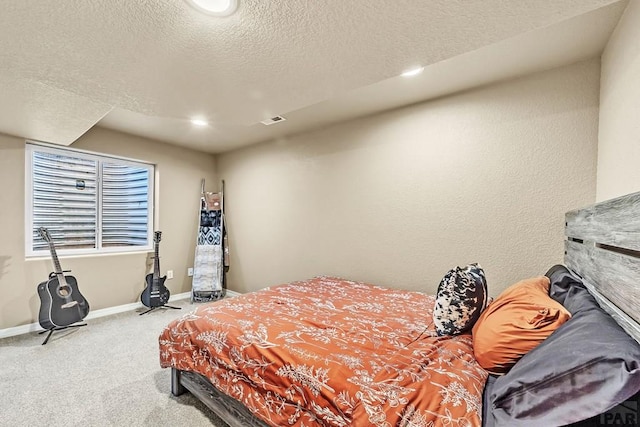 carpeted bedroom featuring a textured ceiling, recessed lighting, visible vents, and baseboards