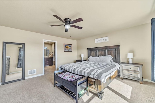 bedroom featuring ceiling fan, connected bathroom, light carpet, visible vents, and baseboards