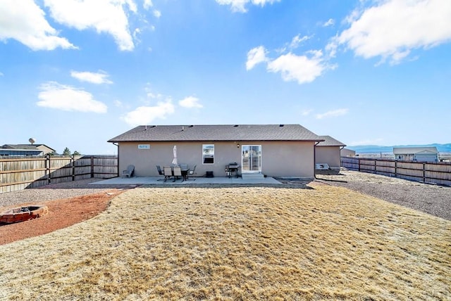 rear view of property with a patio area, a fenced backyard, and stucco siding