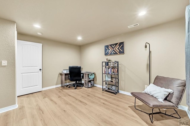 office space featuring recessed lighting, visible vents, light wood-style flooring, and baseboards