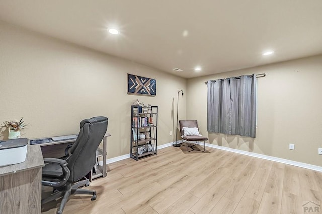 office featuring light wood-style floors, recessed lighting, and baseboards