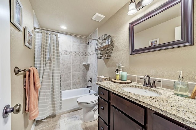 full bathroom featuring a textured wall, tile patterned flooring, toilet, vanity, and shower / bath combination with curtain