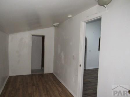 1119 Pine St, Pueblo, CO 81004 - corridor featuring wood finished floors, lofted ceiling, and baseboards