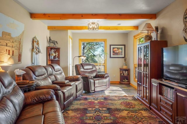 living area featuring beam ceiling, plenty of natural light, and baseboards