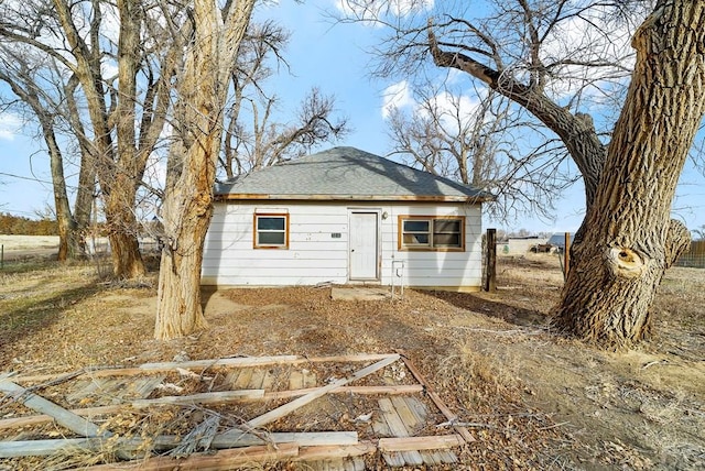 exterior space with roof with shingles