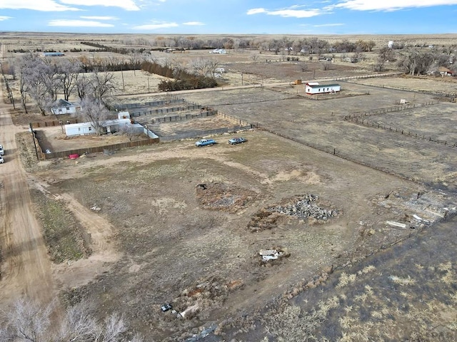 birds eye view of property with a rural view